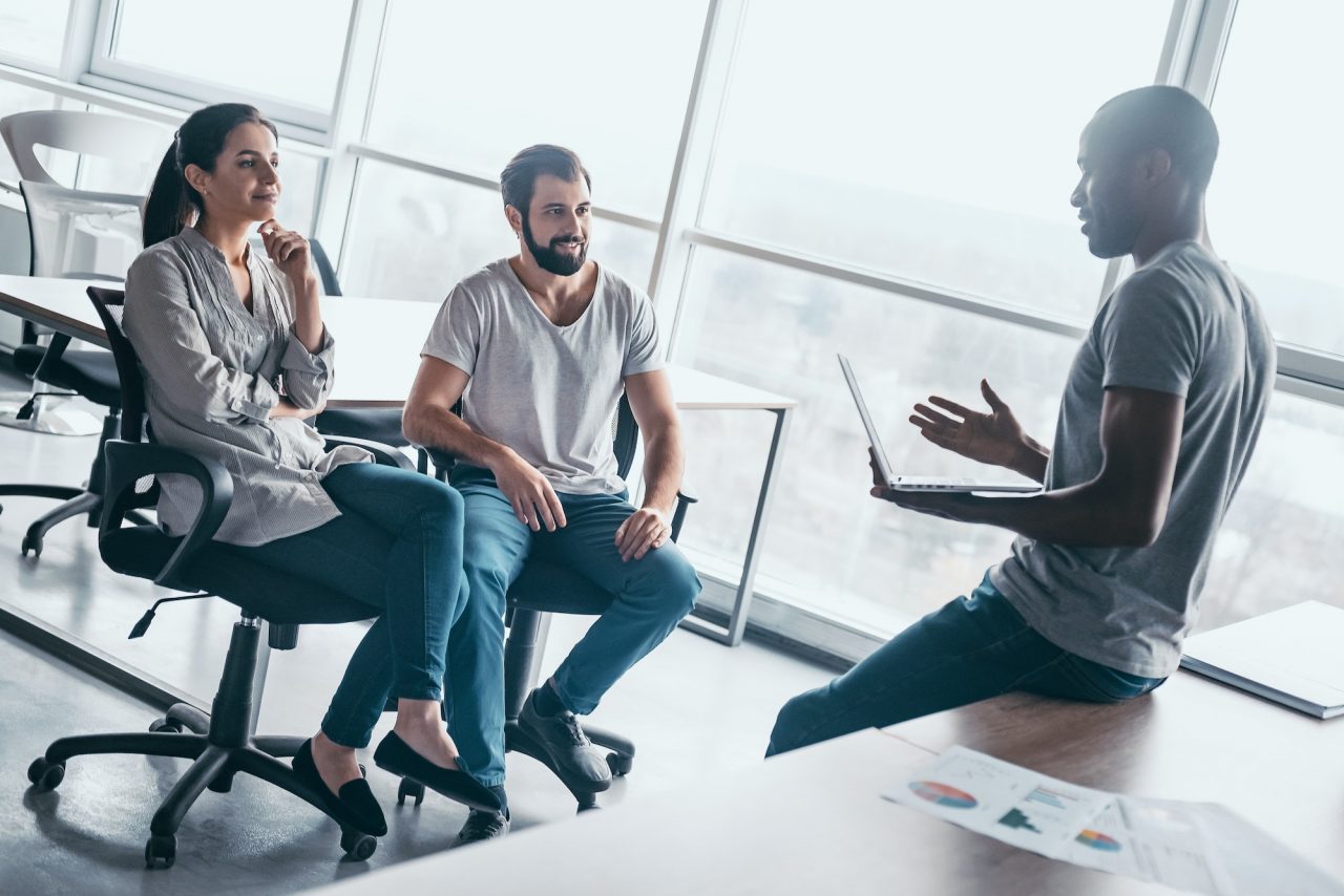 young-professional-team-discussing-business-plan-in-the-office.jpg